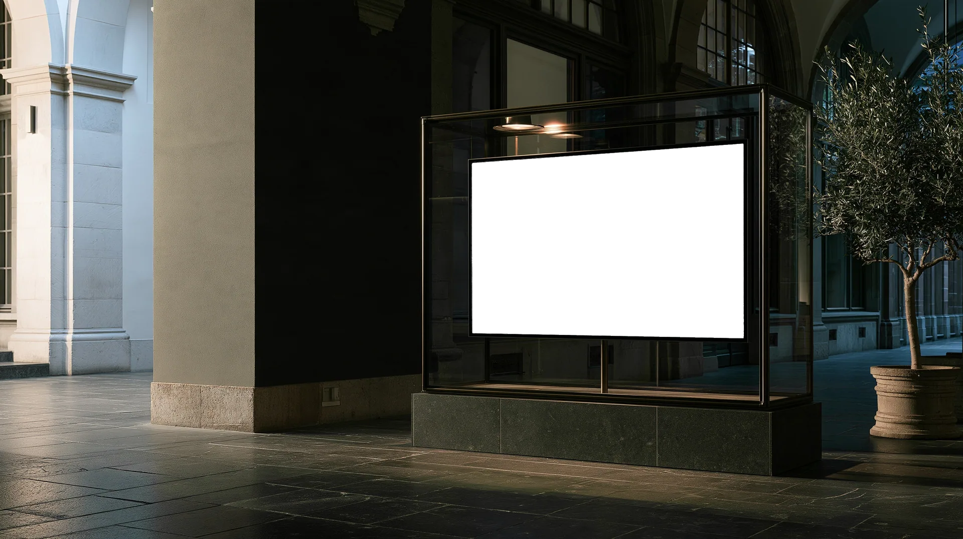 A vaulted stone passage at night, lined with lit glass display cases